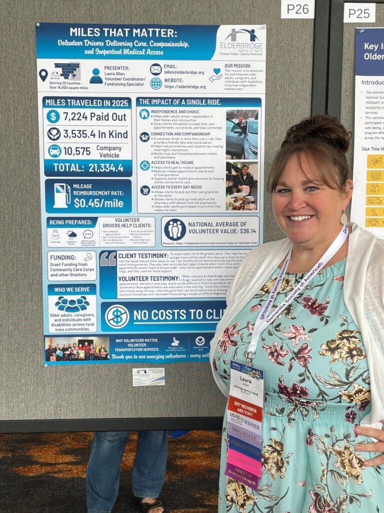 Smiling woman stands next to informational poster