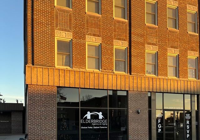 A building with two windows and a sign on the front.